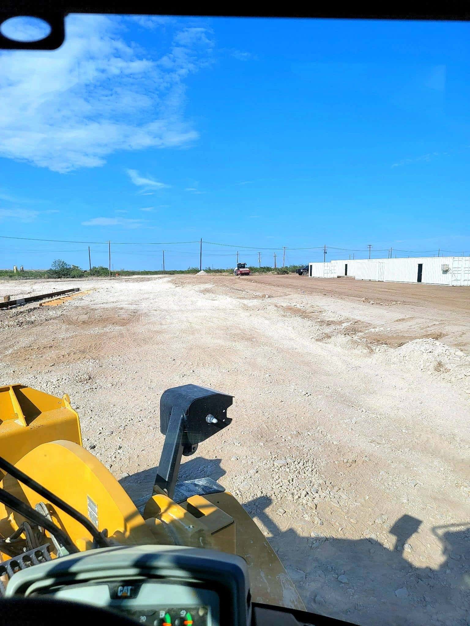 Dozer working a graded yard on a Permian Basin job site