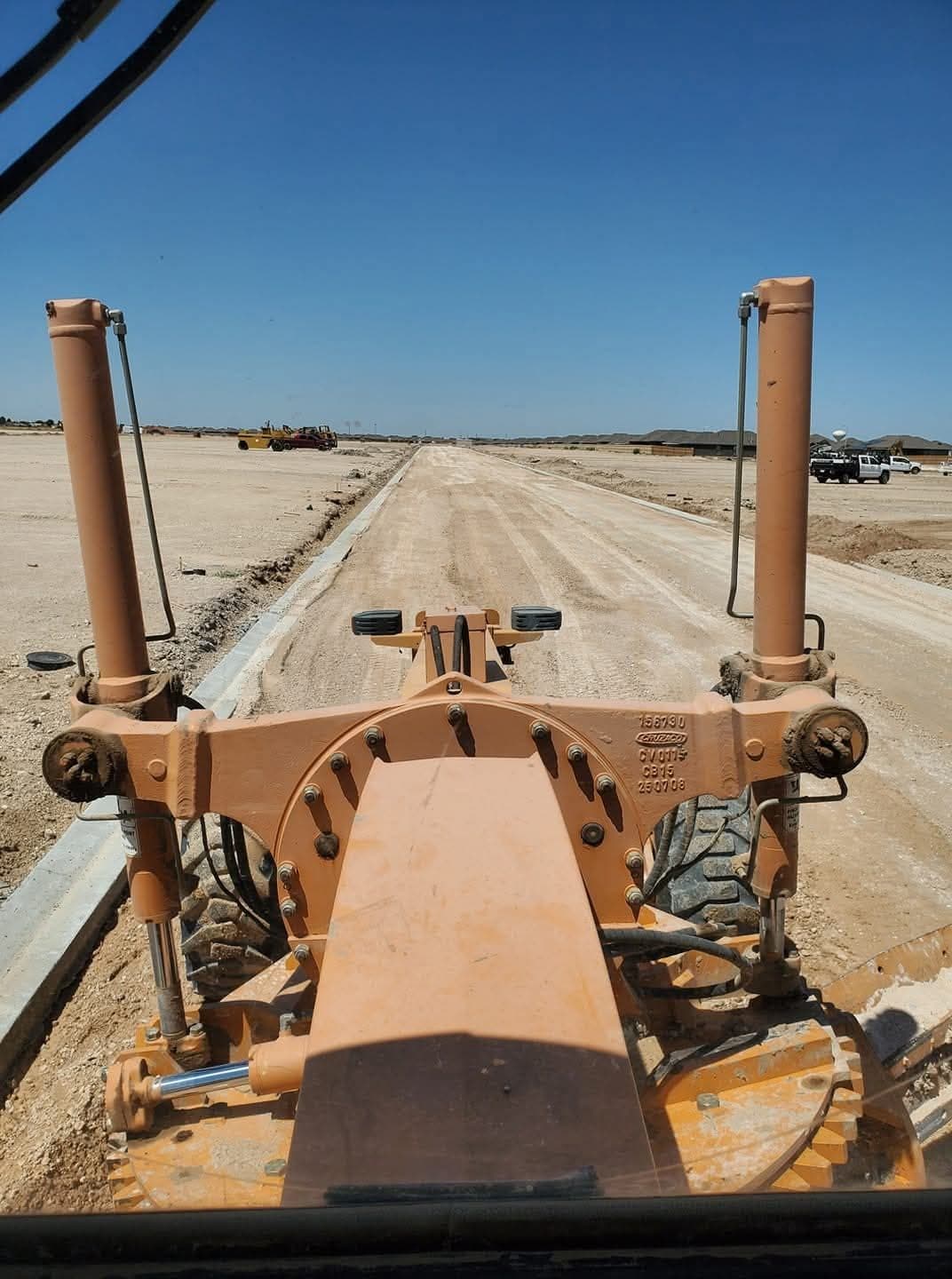Grader blade shaping drainage grade