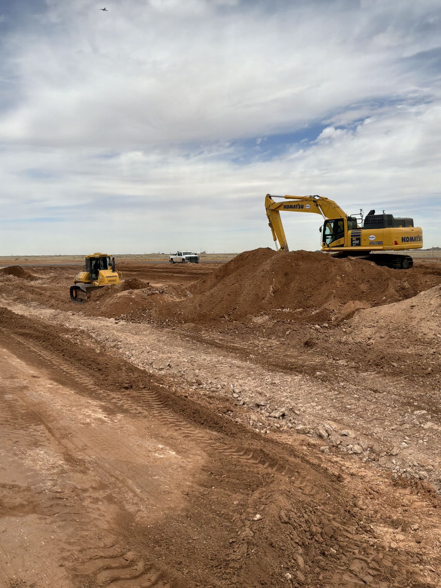Dozer and excavator working the same cut on a Permian Basin land development job