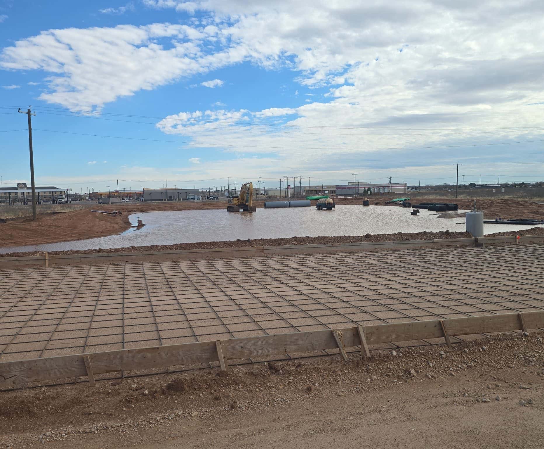 Earthen pond holding water on a Permian Basin property