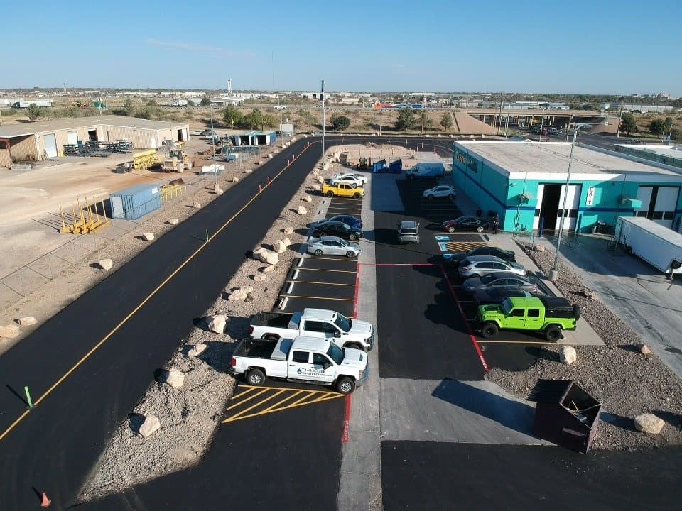 Aerial view of a freshly paved and striped asphalt turn radius on a commercial site in Midland, TX