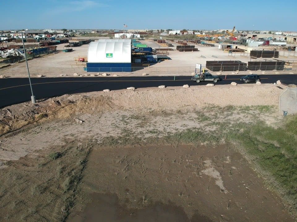 Finished commercial asphalt lot in use with trucks and equipment on it