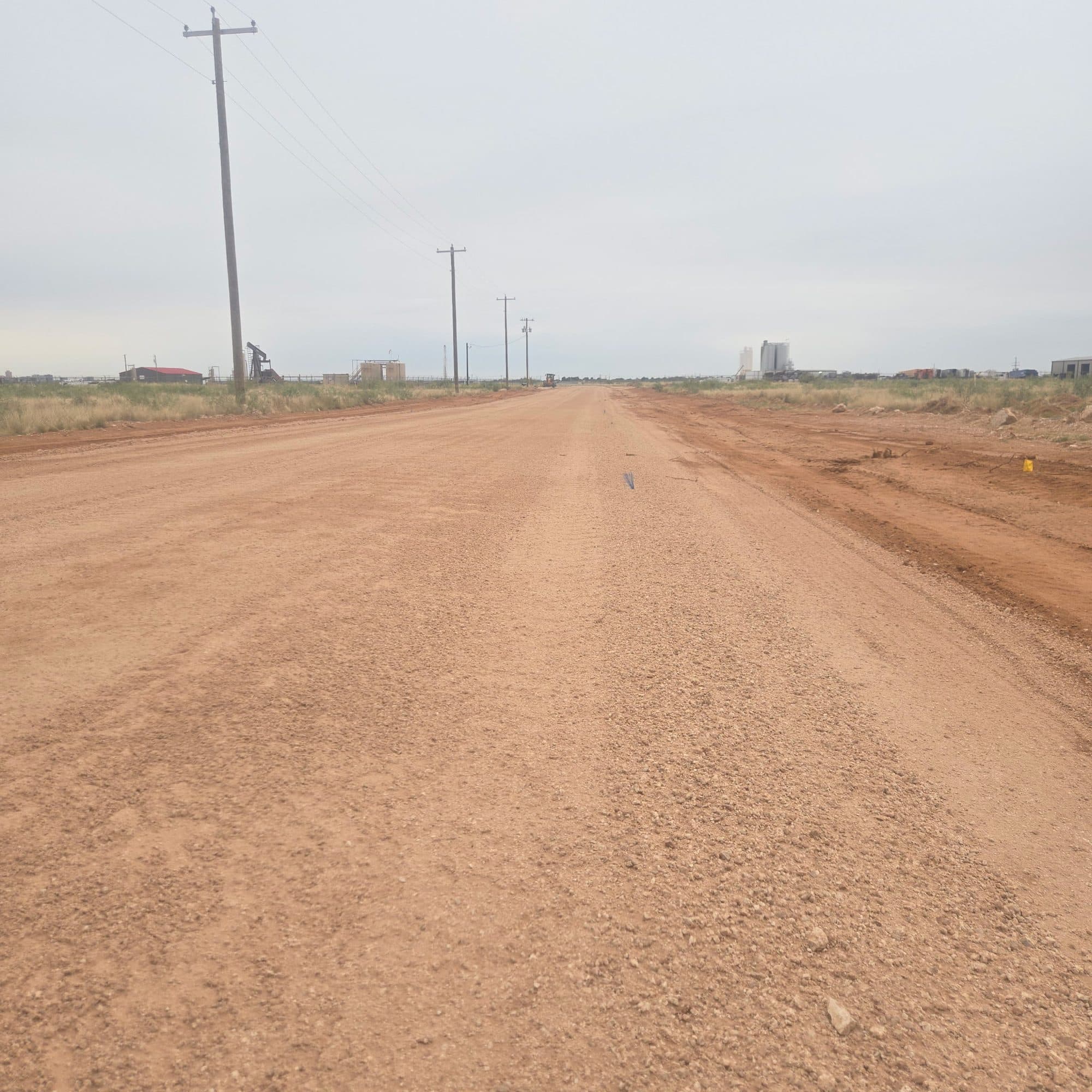 Newly built caliche ranch road running straight to the horizon in West Texas