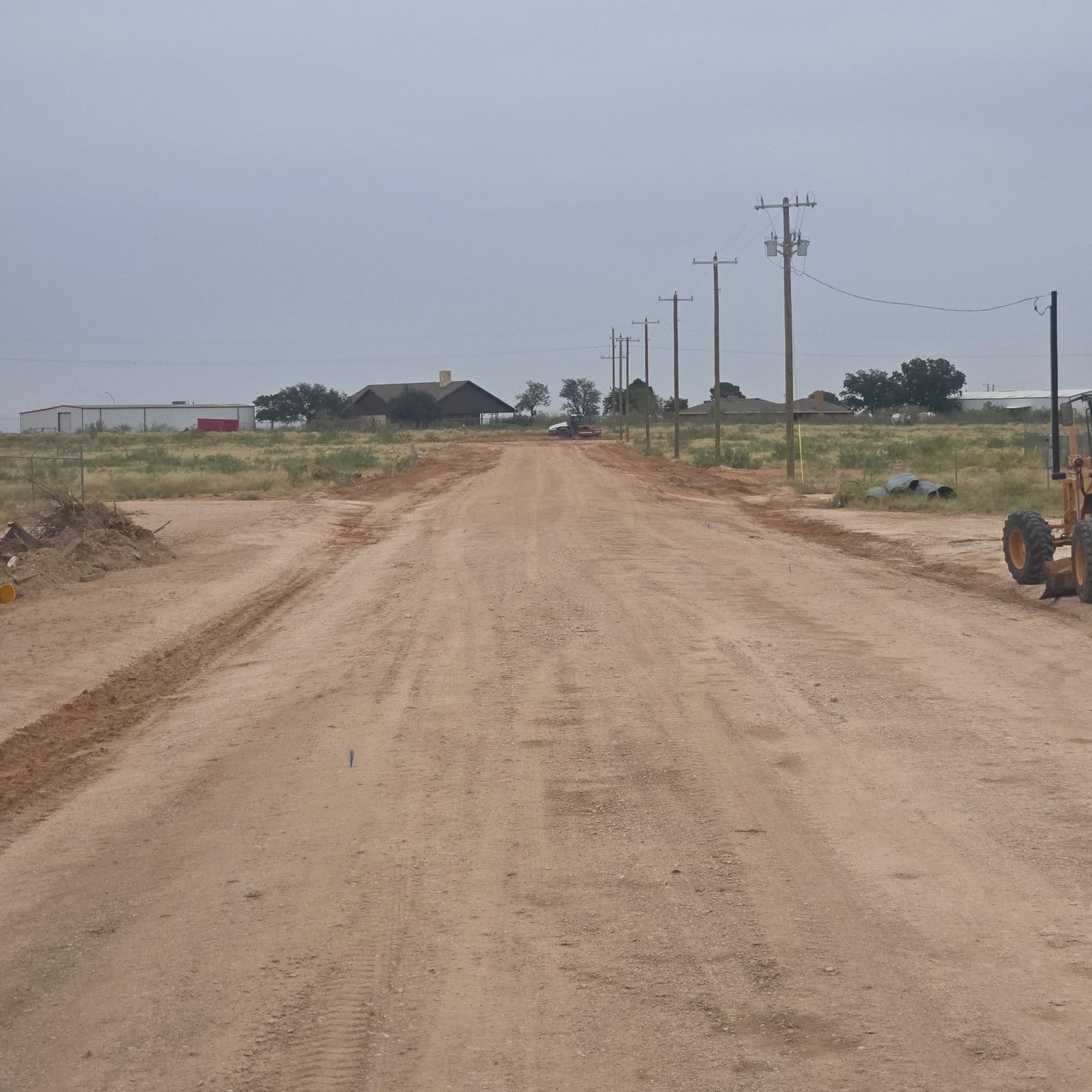 Caliche road crowned and shaped so water sheds to both shoulders