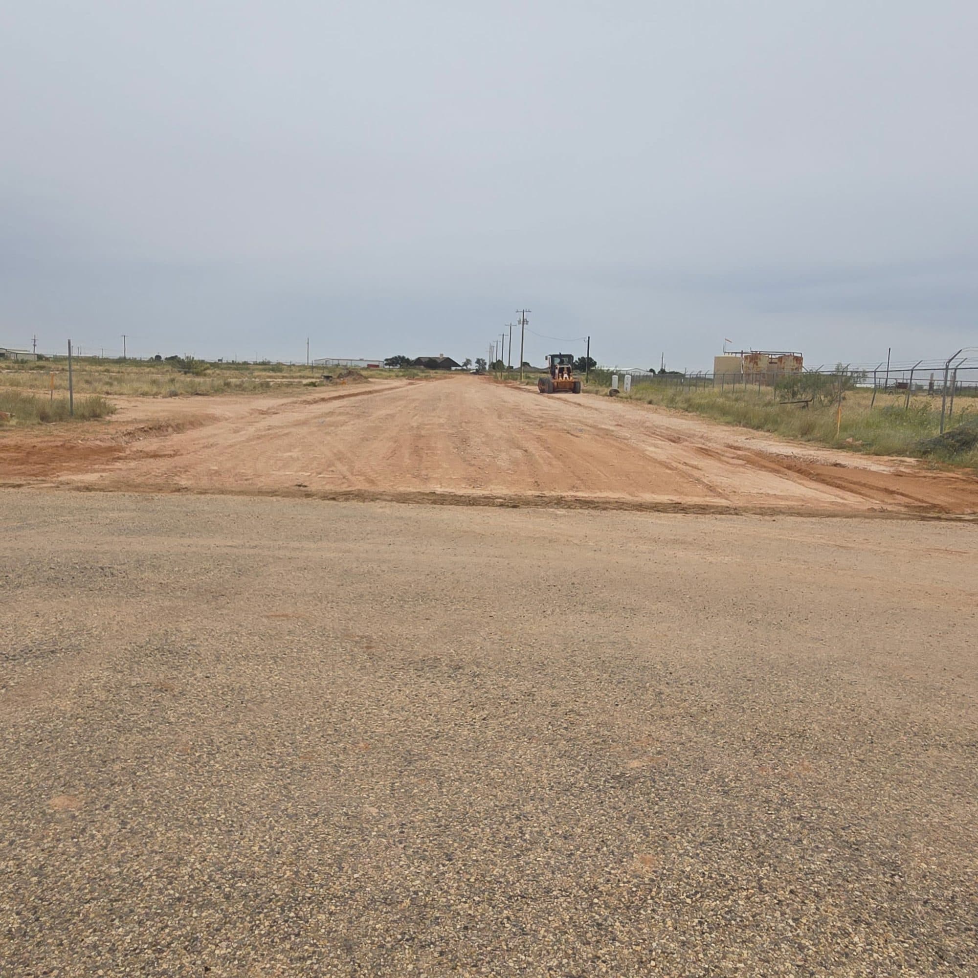 New caliche road tying into existing pavement at the property entrance