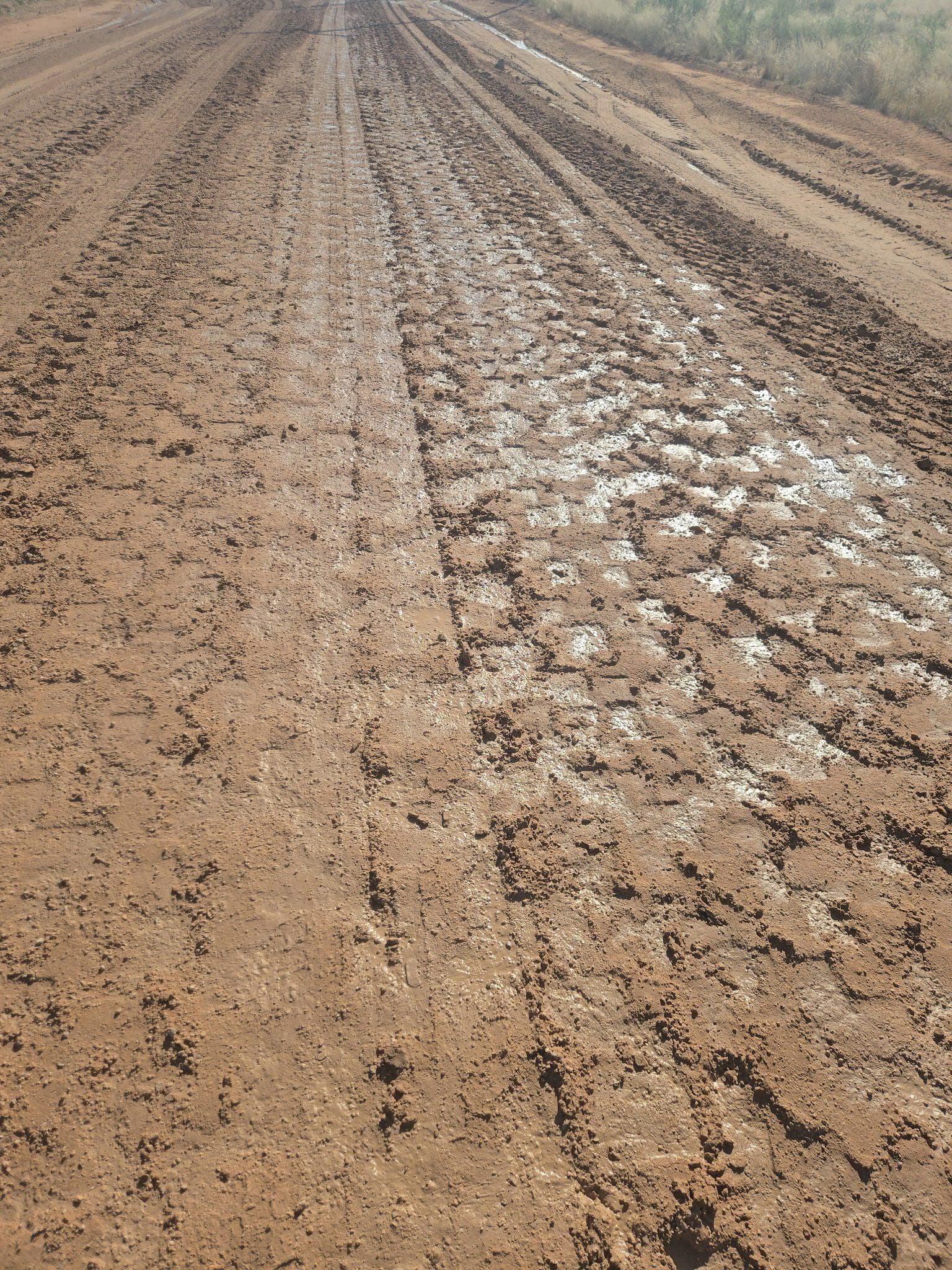 Close view of compacted caliche road base, the layer the pavement depends on