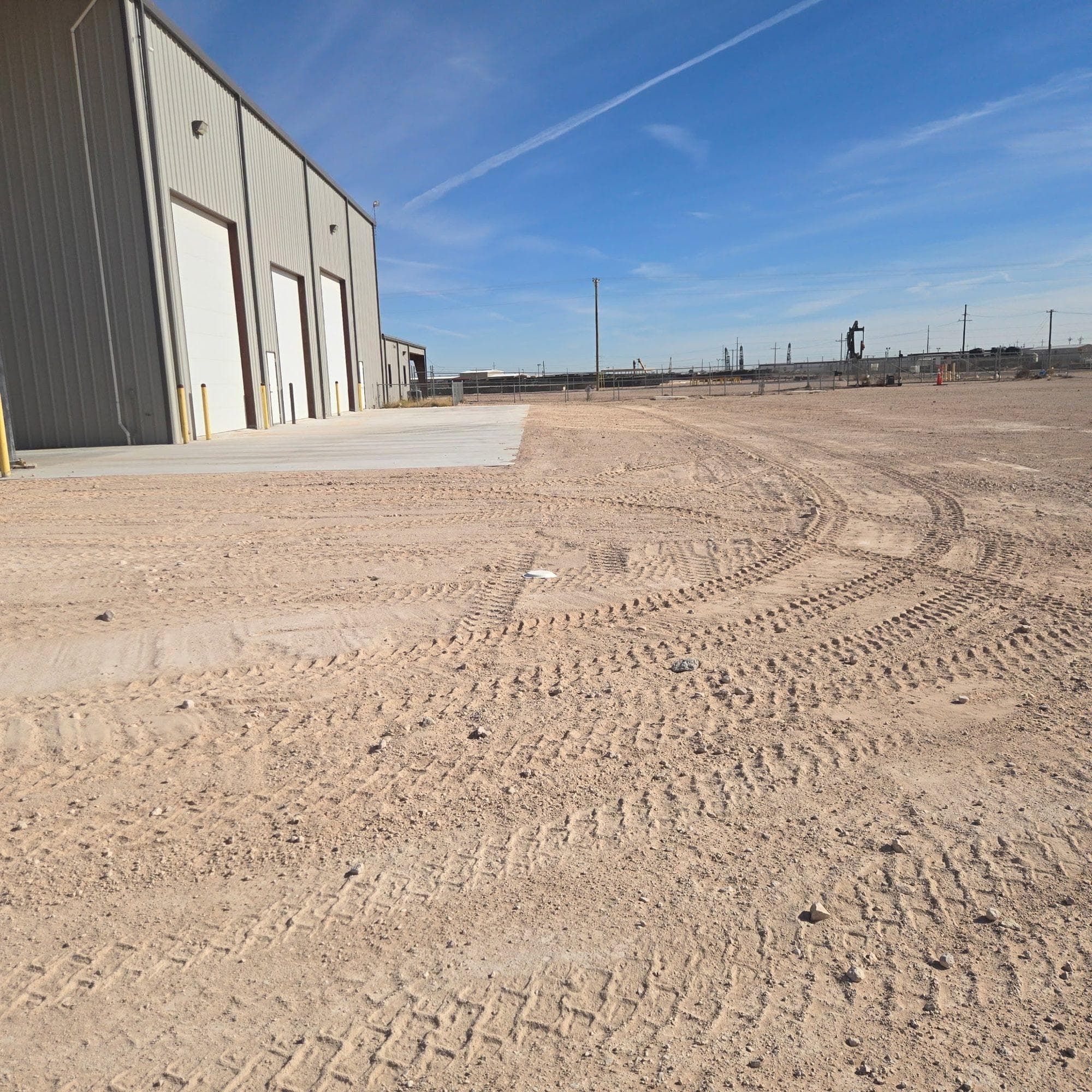 Finished shop building with its yard graded and compacted around it